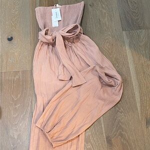 Rose gauze strapless romper with tie waist.